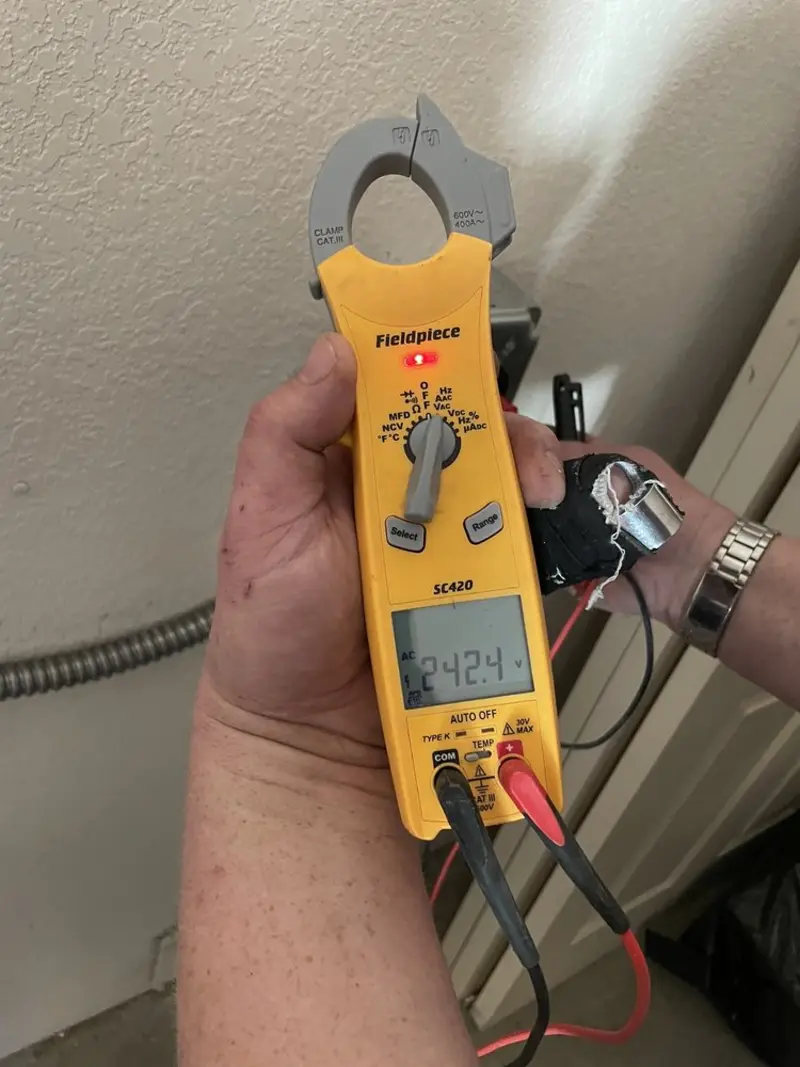 Voltage testing with clamp meter during Electrical Installation Services in Osprey
